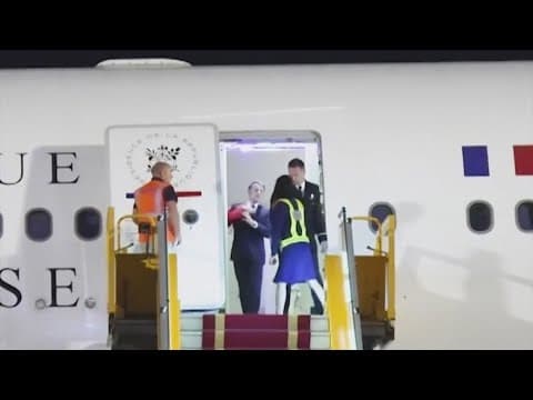 France's first lady seems to push her husband as they land in Vietnam. He says they were joking