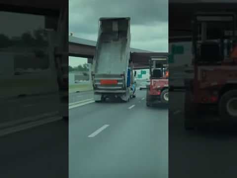 Dump truck with raised bed smashes into overpass bridge
