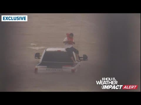 Caught on camera: Man stranded on top of truck being rescued from floodwaters on Highway 288