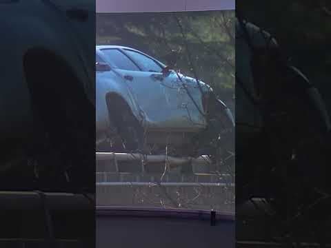 Driver dies after crash where car dangles on I-5 guardrail in Seattle