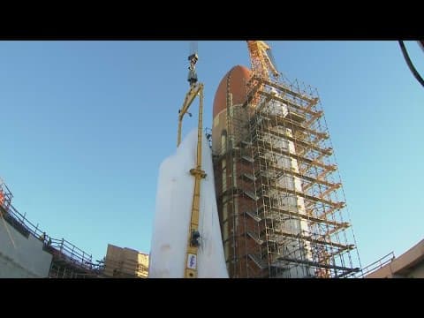 Space Shuttle Endeavour hoisted for installation in vertical display at Los Angeles science museum