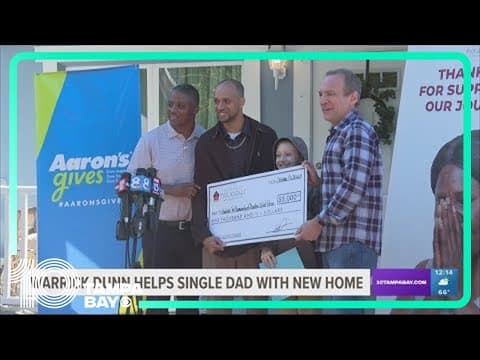 Former Buc Warrick Dunn helps single dad with new home