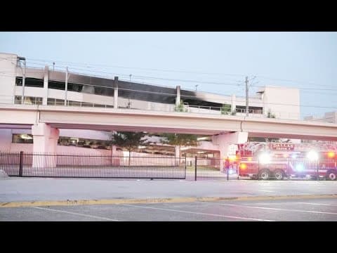 Dallas firefighters work to put out flames in parking garage
