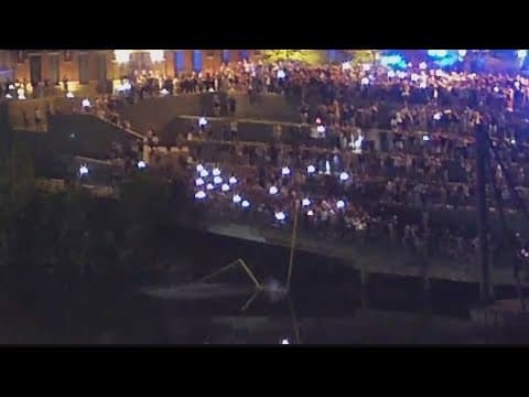 Vanderbilt students walk through Broadway to throw goal posts in the river