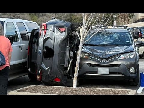 Car ends up wedged between two vehicles in H-E-B parking lot in the Woodlands