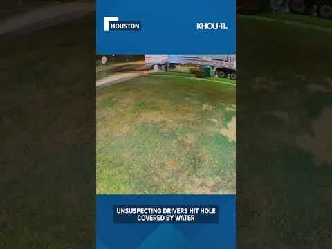 Watch and listen as unsuspecting drivers hit hole covered by water #shorts