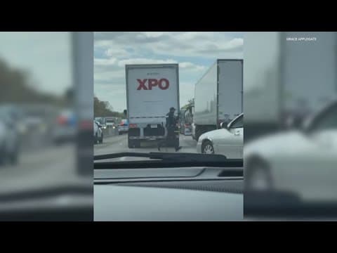 Cellphone video shows police with rifles searching for armed suspects after chase.