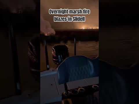 Two men use outboard motor to battle marsh fire in Slidell. Courtesy: Benjamin Farmer & Perry Barras