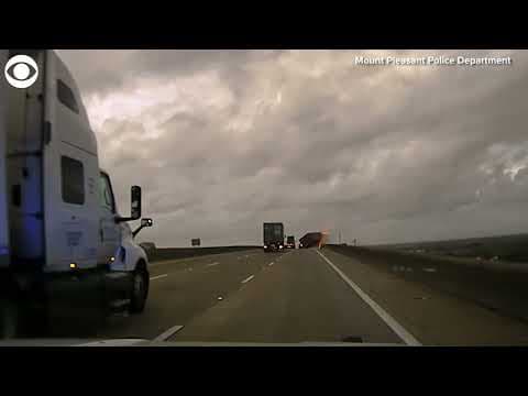 Container flies off truck in high winds and crushes police cruiser