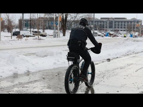 IMPD officer patrols streets on bicycle during winter snow storm