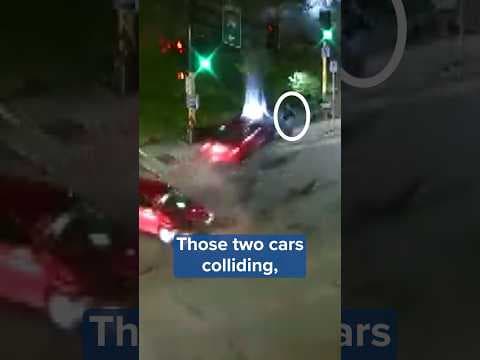 An incredibly close call between a crashing car and a pedestrian, caught on camera.