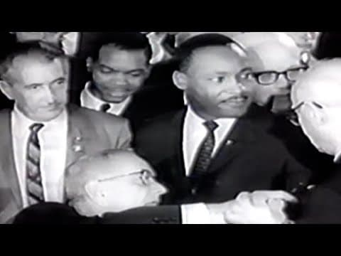 President Lyndon B. Johnson signs Civil Rights Act of 1964 with Martin Luther King Jr. in attendance