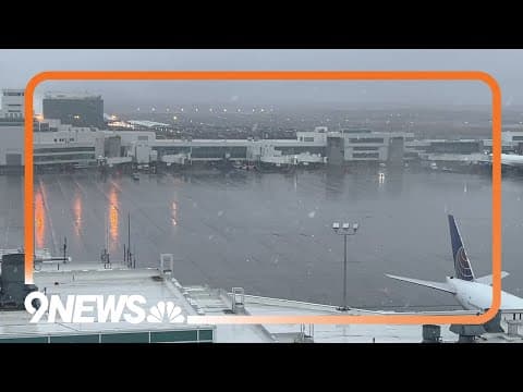 Snow falls at Denver International Airport