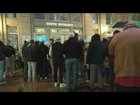 Mavs fans line up outside the ACC in the middle of a winter weather mix