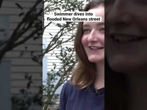 Swimmer dives into flooded street