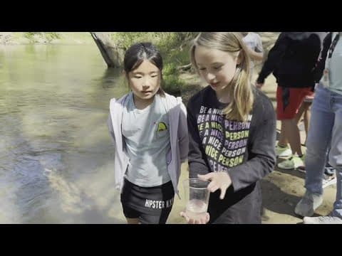 Students release trout they raised back into the environment
