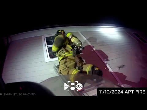 Volunteer firefighters rescue a two-year-old from a burning apartment