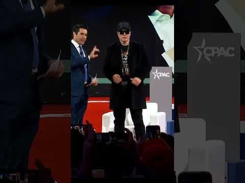 Elon Musk wields chainsaw on stage