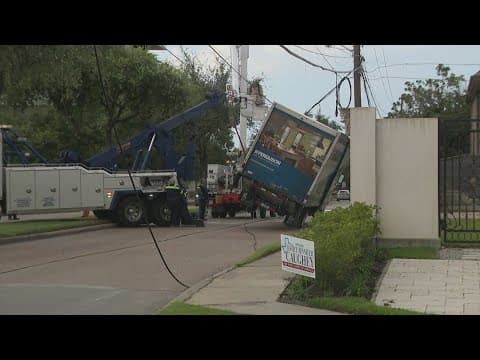 Truck tips over after getting caught in hanging utility lines in west Houston