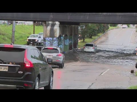 Cars drive through flooded streets in New Orleans as heavy rain moves through area