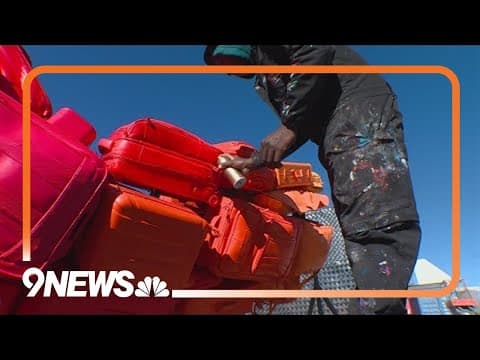 New sculpture made from upcycled luggage being installed at DIA