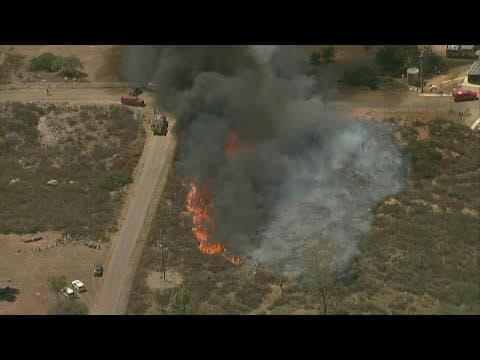 Fire crews battle vegetation fire burning east of Ramona in Witch Creek