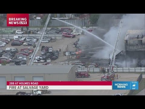 Firefighters battle fire at salvage yard along Highway 288
