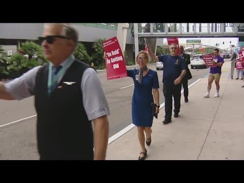 United Airlines flight attendants demonstrate outside San Diego International Airport