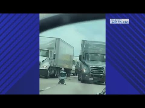 Cellphone video shows woman sitting on I-45 in Houston with a gun