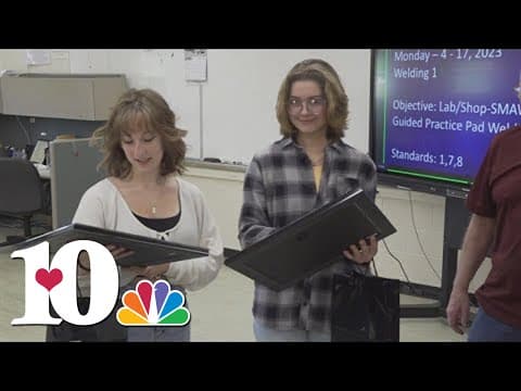 Students help put up flags at veterans cemetery