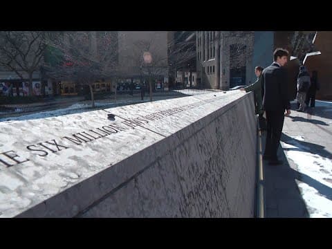 Visitors honor victims of the Holocaust during memorial service at the Ohio Statehouse