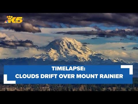 Clouds drift over Mount Rainier at sunset