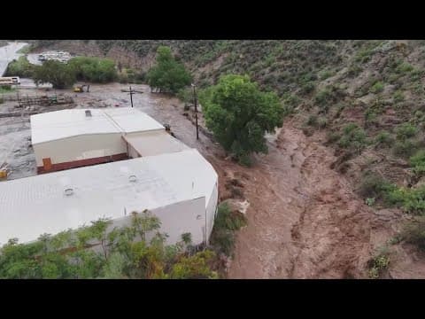 Flash floods hit Arizona, washing away roads and flooding buildings