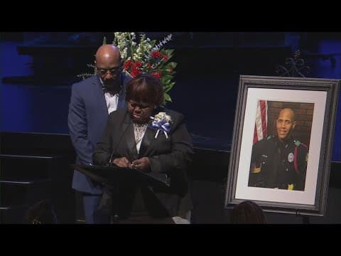Cherie Jeffrey, mother of officer Darron Burks, speaks at her son's celebration of life service