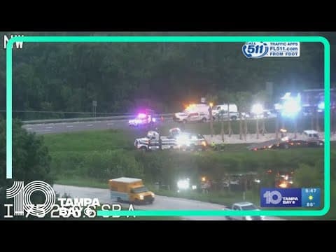 Multiple tow trucks work to pull car out of retention pond off I-75