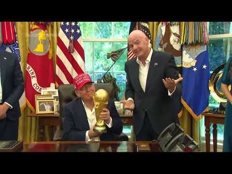 Trump holds World Cup trophy and is given finals ticket as he announces 2026 draw to be held in DC