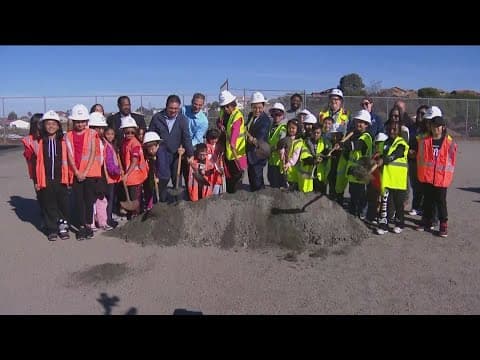 Paradise Hills Elementary School students celebrate the start of construction for a new soccer field