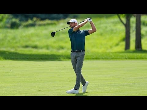 Volunteers prep the golf course for the 3M Open in Blaine