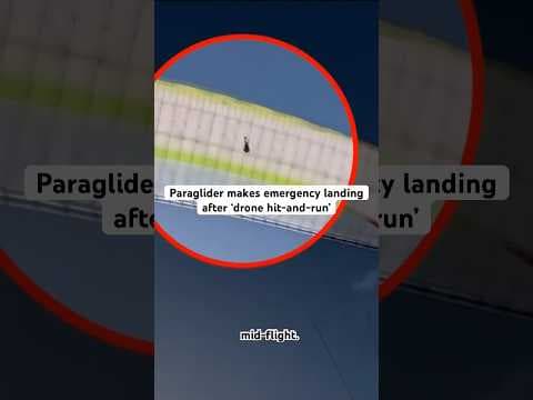 A video posted to YouTube shows the urgent landing by a paraglider after a drone gets tangled in.