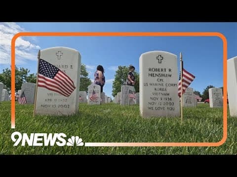 Volunteers lay flags at Fort Logan National Cemetery to remember our fallen service members