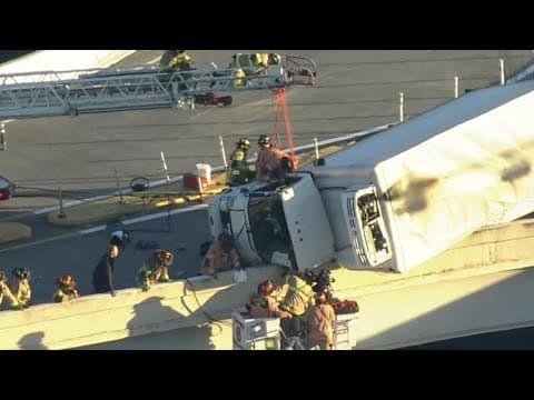 Video shows driver being rescued from box truck hanging off Houston overpass