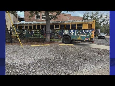 Woman driving school bus full of graffiti crashes into school in Covington