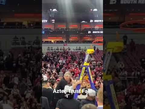 SDSU Aztecs coach Dutcher does a trust fall after cutting down the nets following Elite 8 win #sdsu