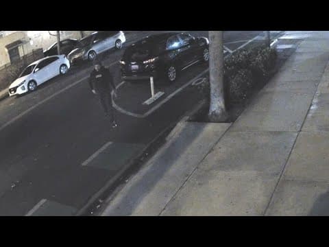 Surveillance Video | Man writes, places fake parking ticket on a vehicle